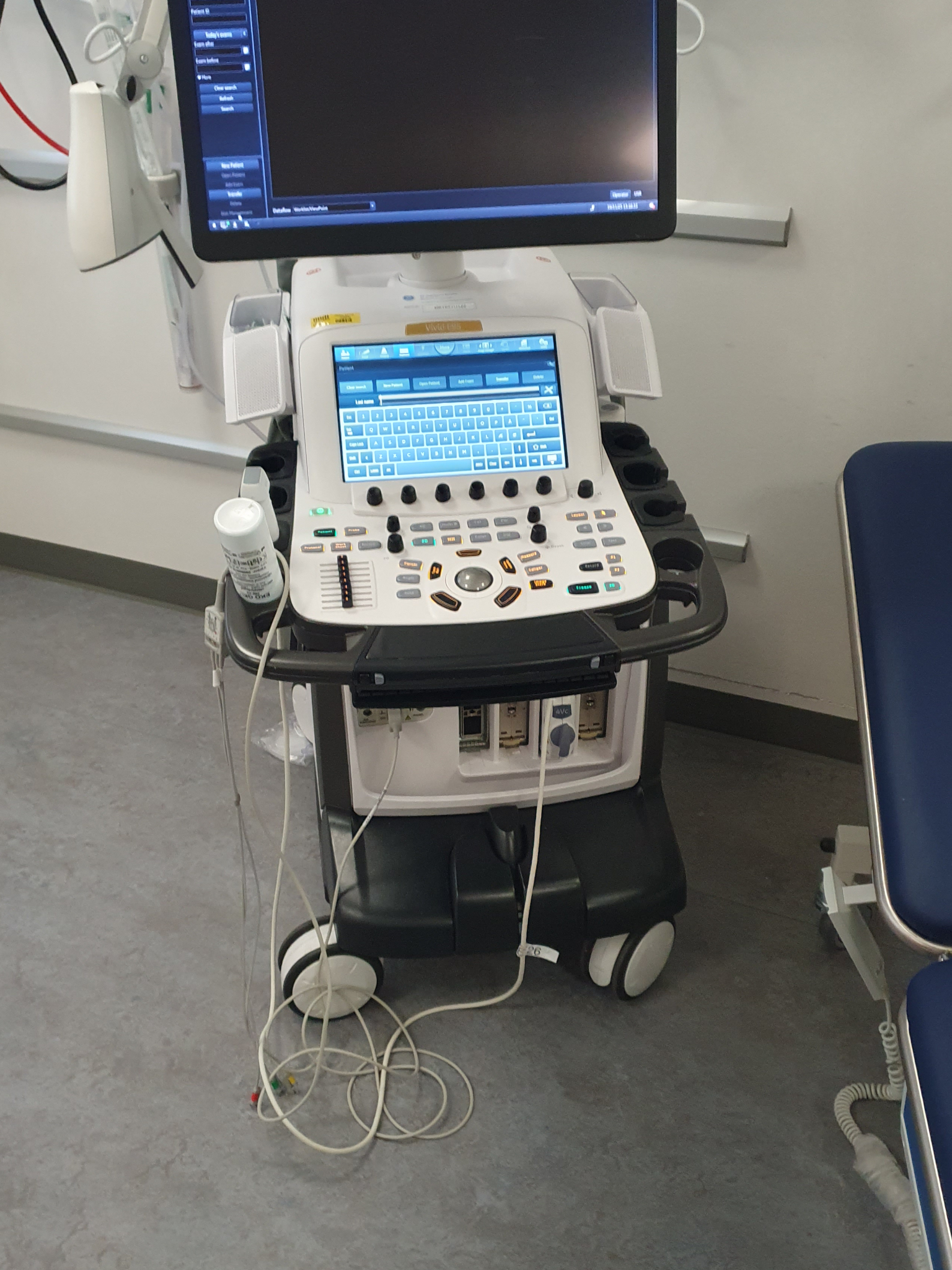 Cable coiled on the floor next to ultrasound machine wheels