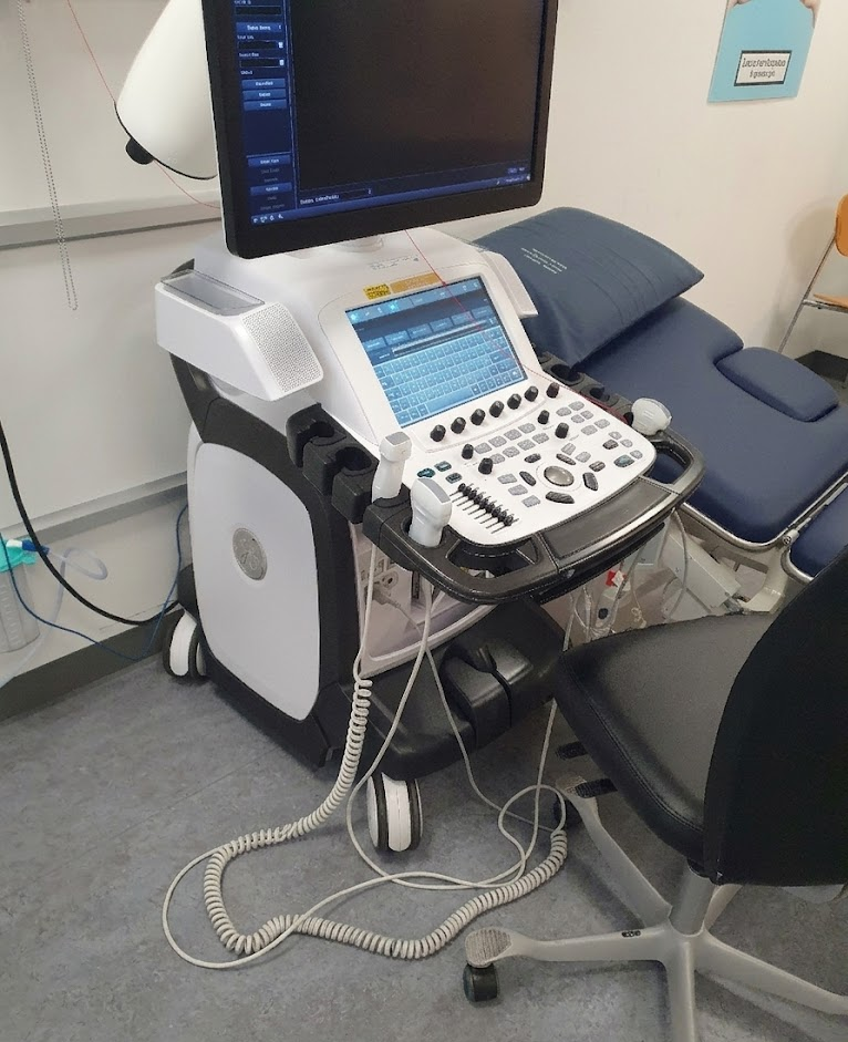 Cable coiled on the floor next to ultrasound machine wheels